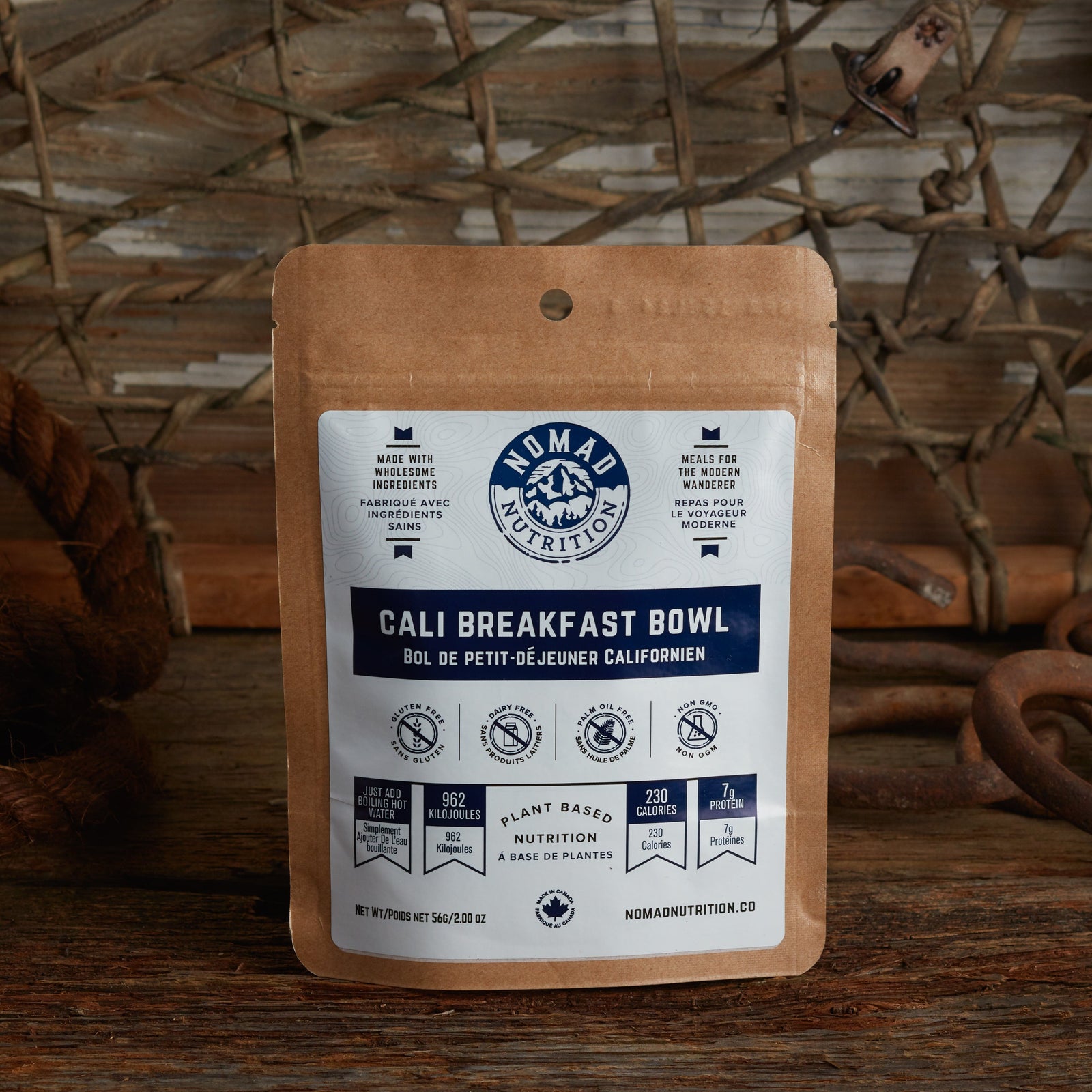 Nomad Nutrition California Breakfast Bowl 56g snack size with outdoor equipments on table top.