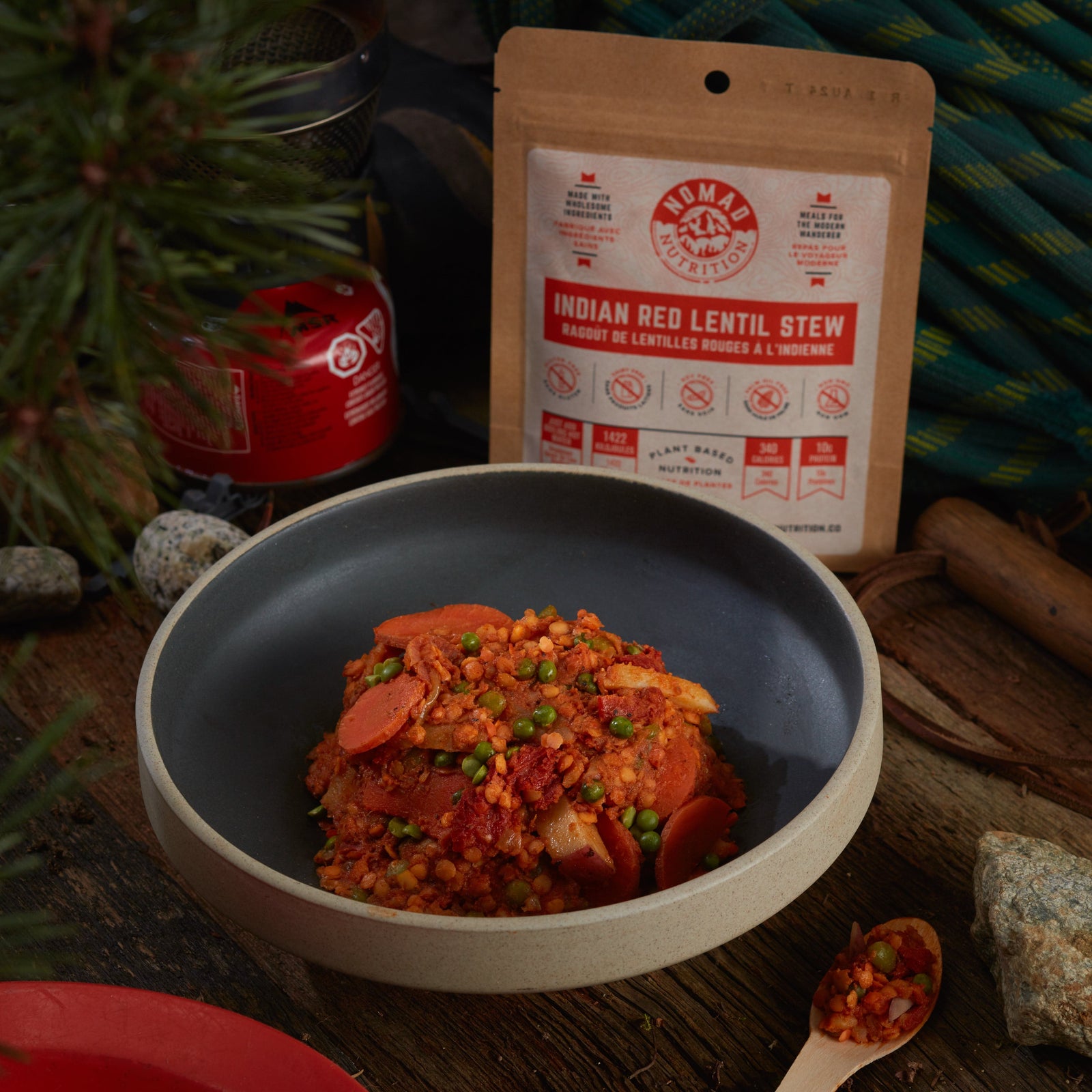 Rehydrated Nomad Nutrition Indian Red Lentil Stew in a bowl with 56g snack size on table top outdoors. No additional cooking required. Picture for reference only.