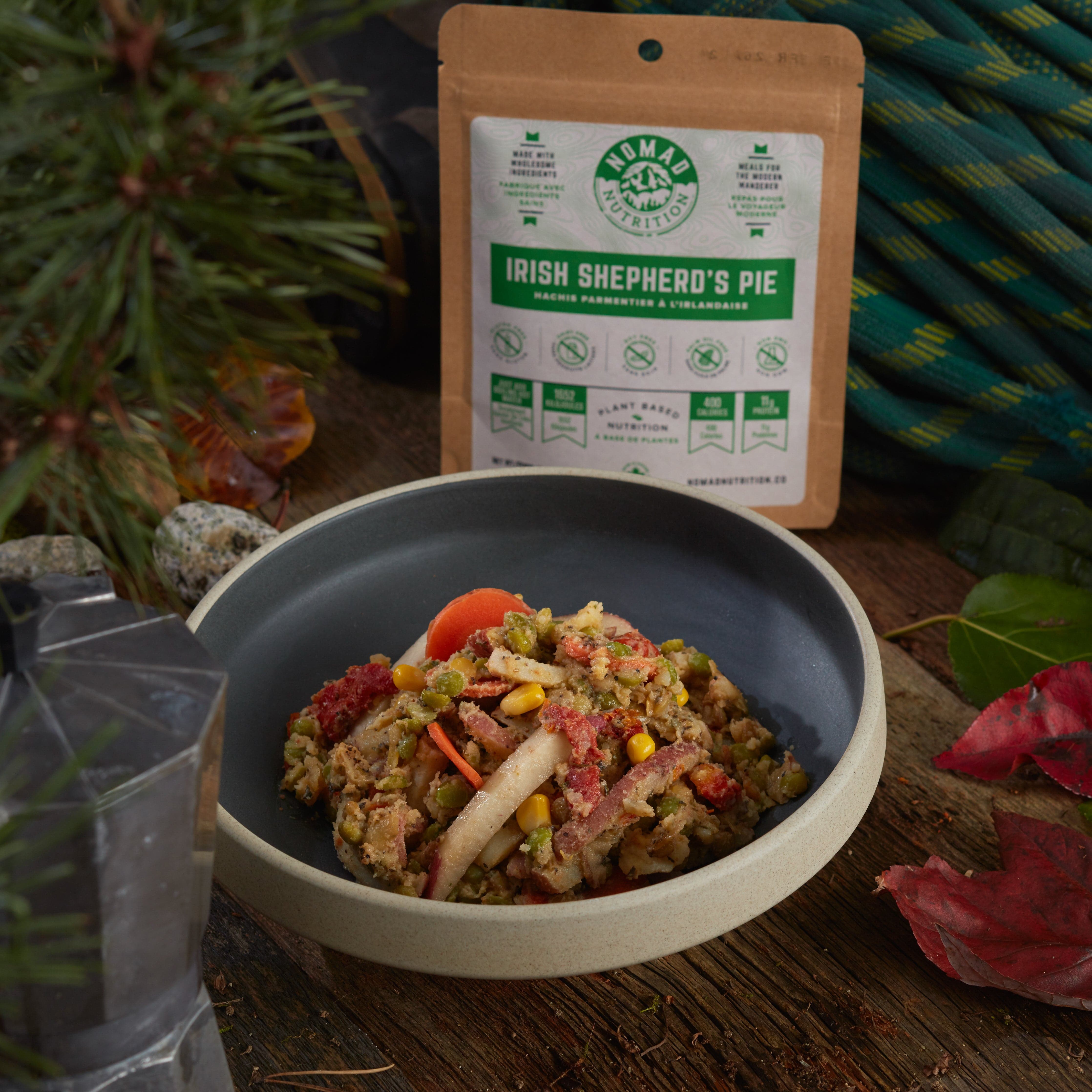 Rehydrated Nomad Nutrition Irish Shepherd's Pie in a bowl with 56g snack size on table top outdoors. No additional cooking required.