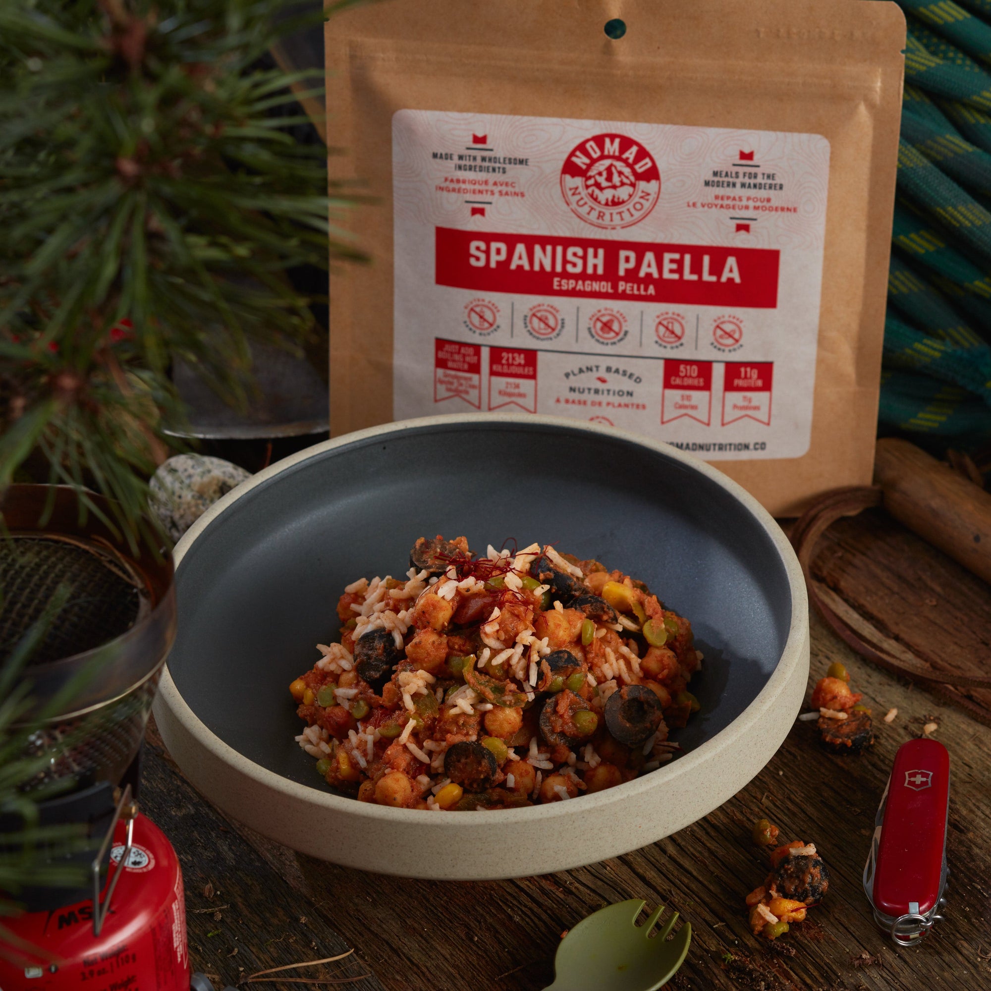 Rehydrated Nomad Nutrition Spanish Paella in a bowl with 112g meal size on table top outdoors. No additional cooking required. 