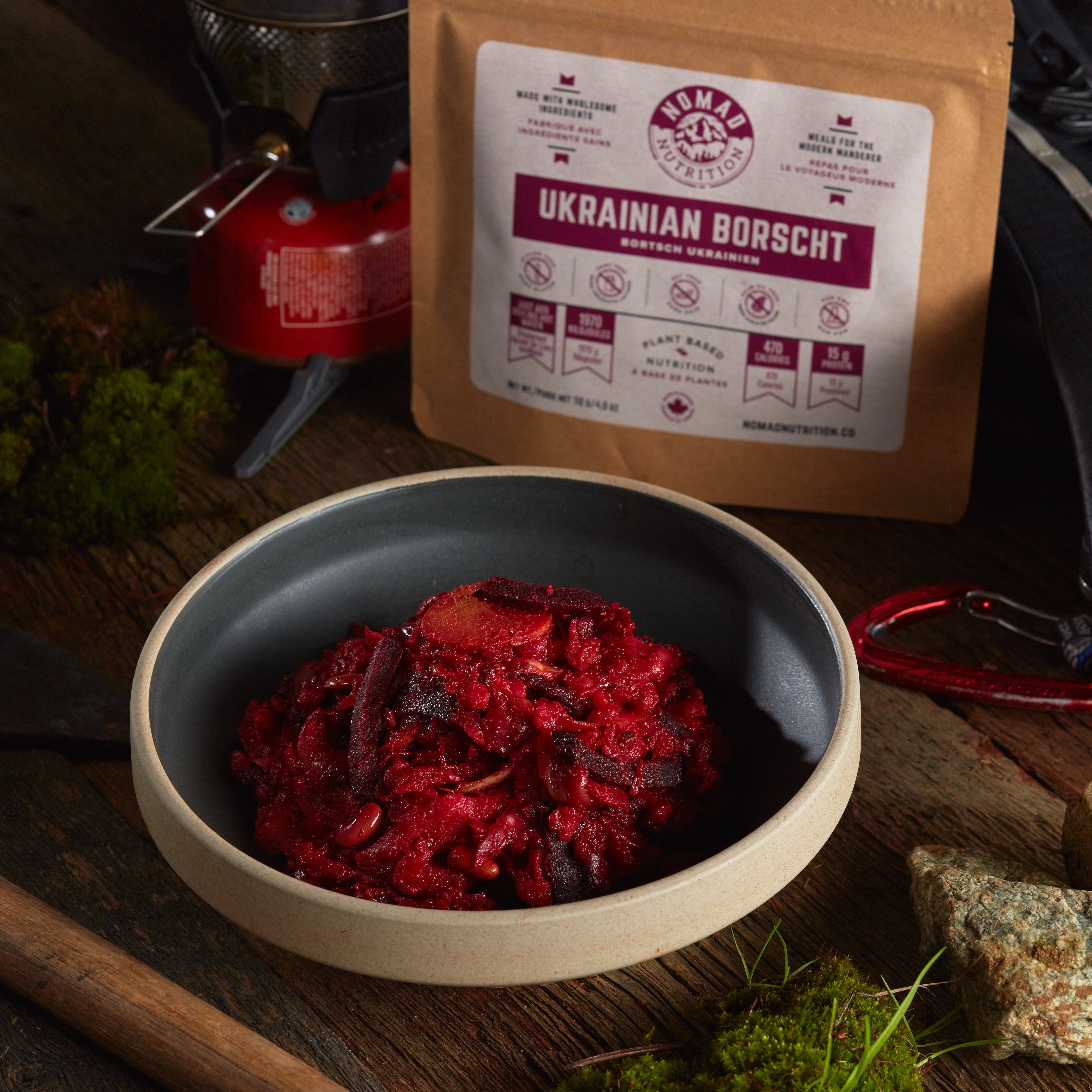 Rehydrated Nomad Nutrition Ukrainian Borscht in a bowl with 112g meal size on table top outdoors. No additional cooking required.