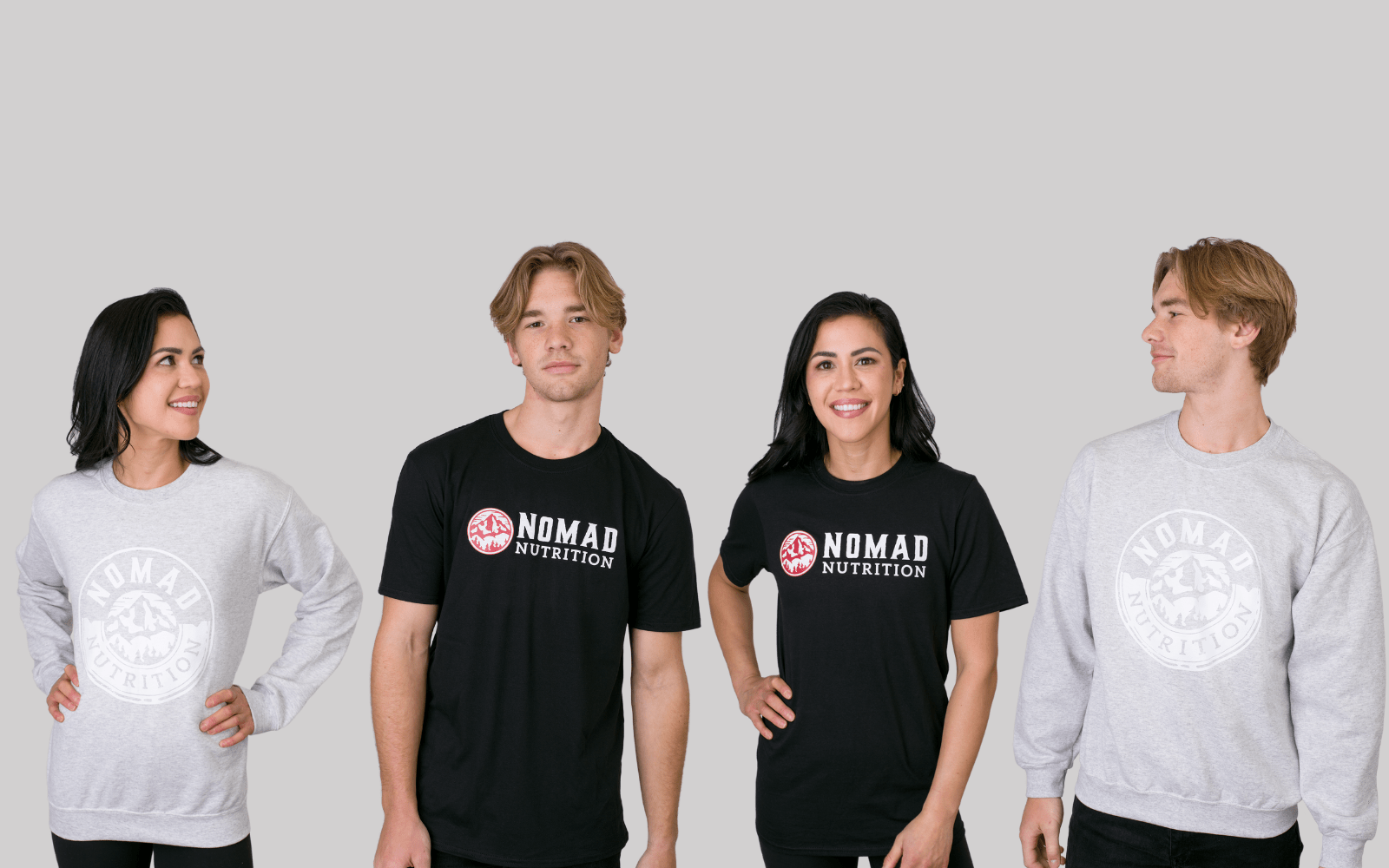 Nomad Nutrition Swag Collection featuring models wearing Shadow Sweatshirt and Logo T-shirt. Available in S, M, L, XL, and XXL.