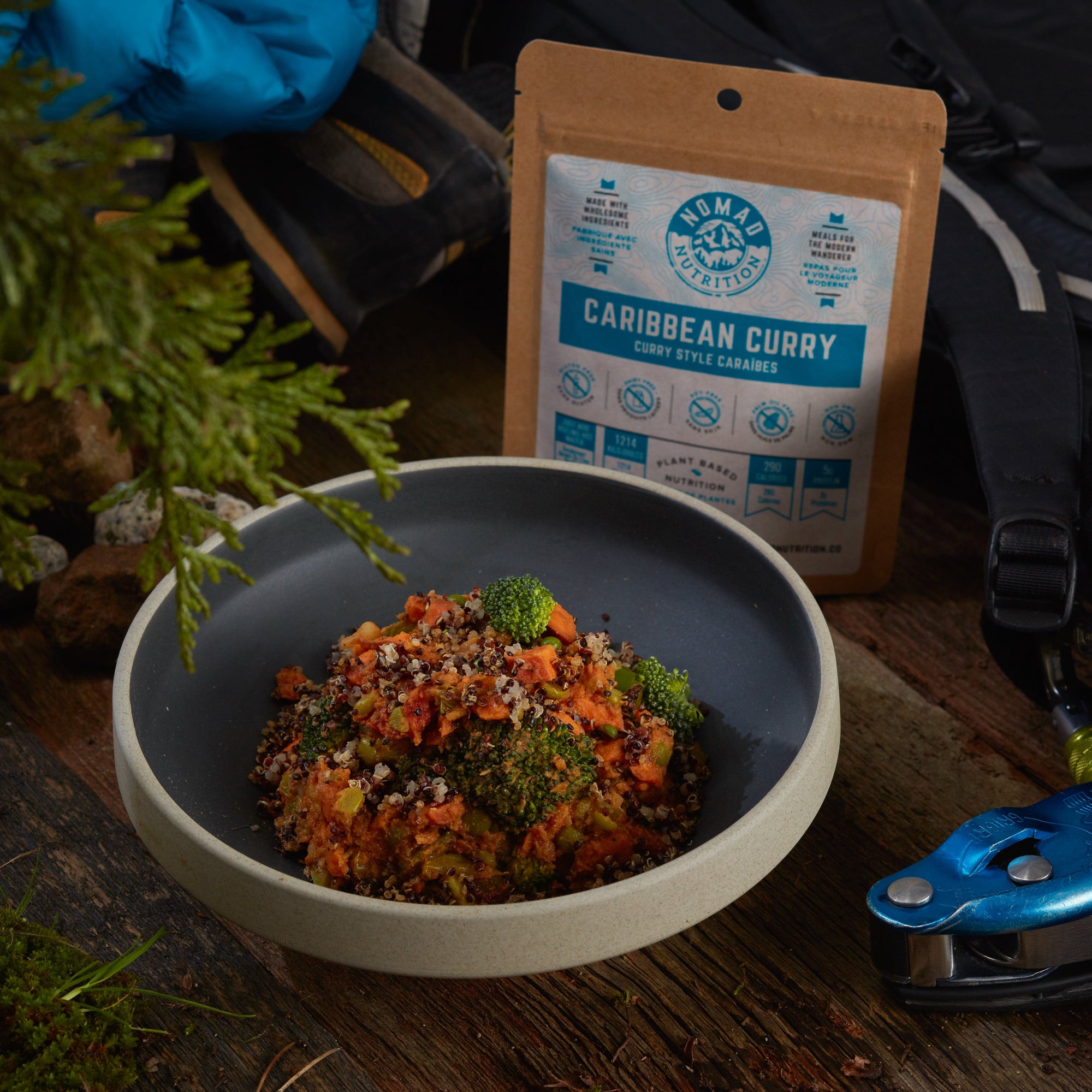 Rehydrated Nomad Nutrition Caribbean Curry in a bowl with 56g snack size on table top outdoors. No additional cooking required. 