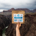 Nomad Nutrition Caribbean Curry, vegan dehydrated adventure, gluten-free, plant-based meal, overlooking the canyon valley at a national park.