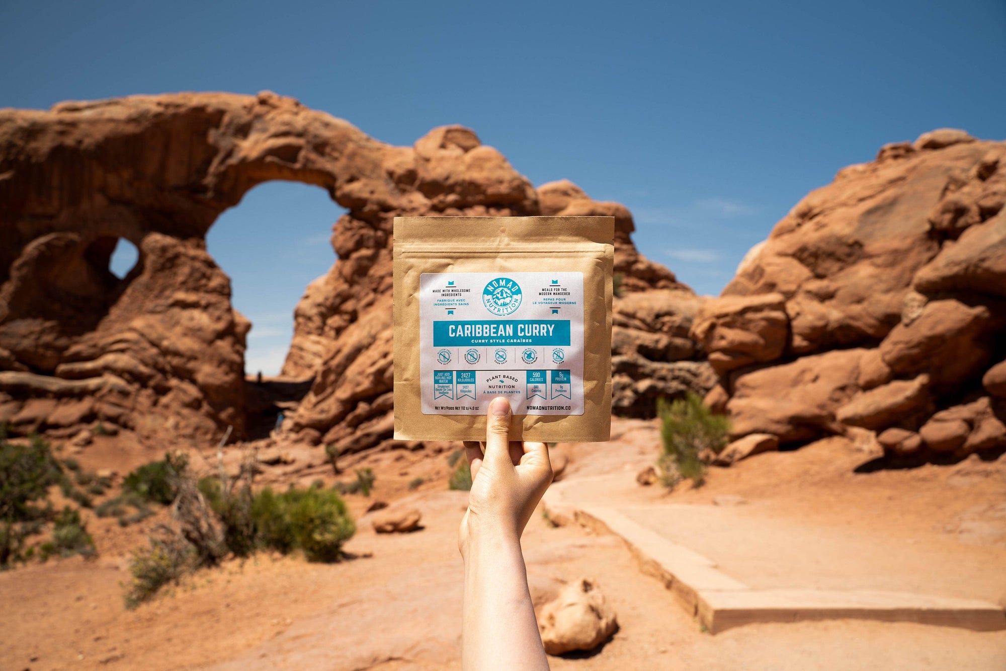 Nomad Nutrition Carribean Curry, vegan dehydrated adventure, camping, plant-based, gluten-free meal picture at Double Arch Trail, Arches National Park. 