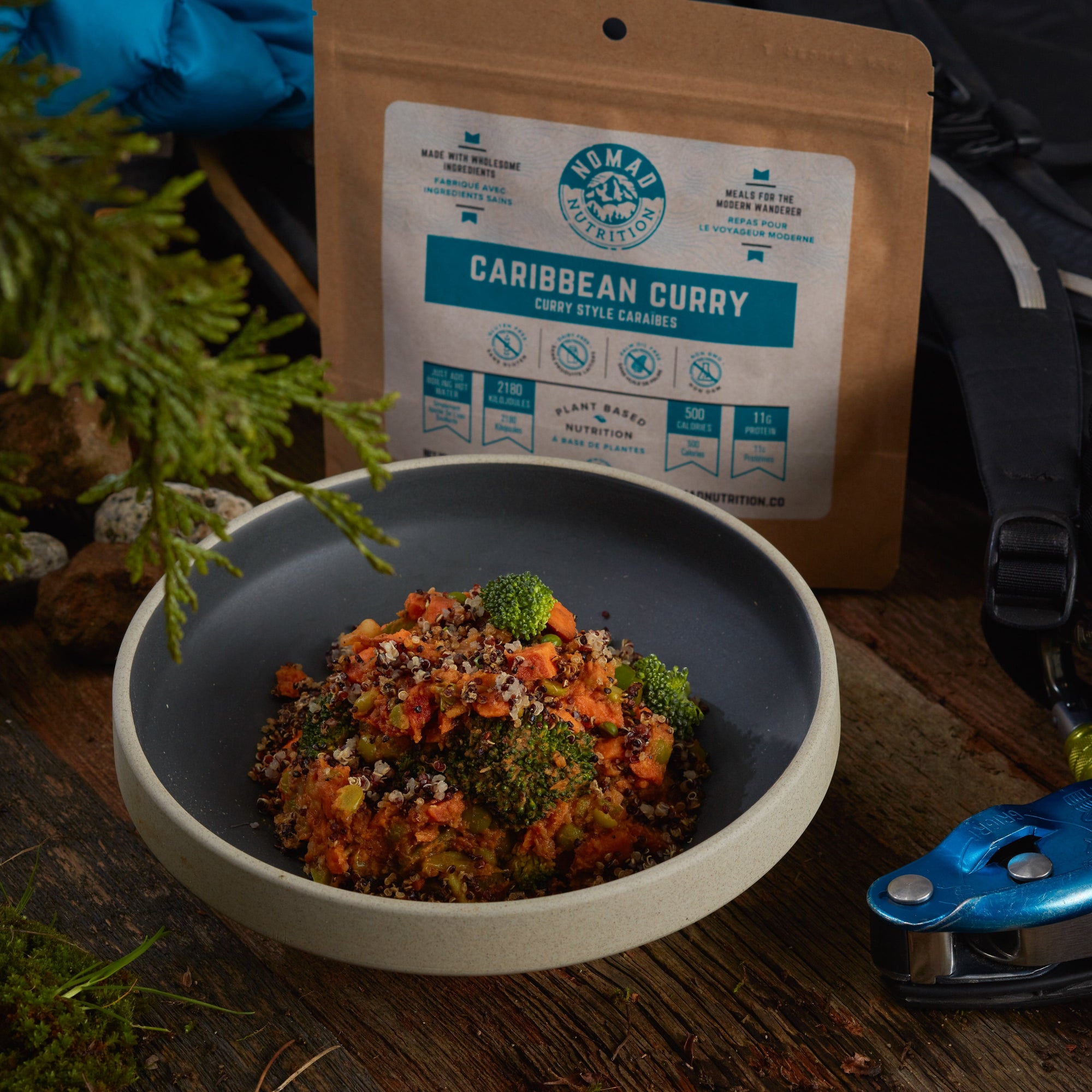 Rehydrated Nomad Nutrition Caribbean Curry in a bowl with 112g meal size on table top outdoors. No additional cooking required. 