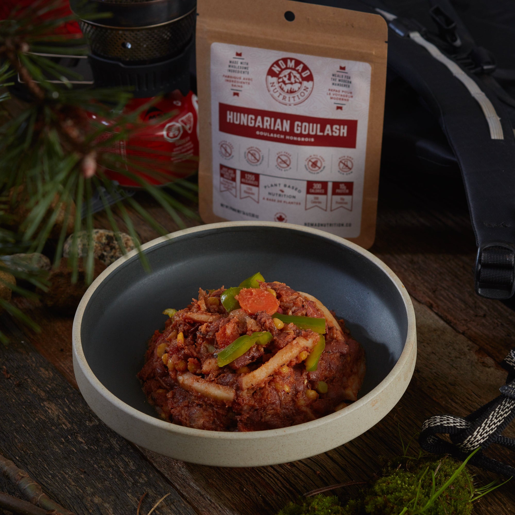 Rehydrated Nomad Nutrition Hungarian Goulash in a bowl with 56g snack size on table top outdoors. No additional cooking required. 