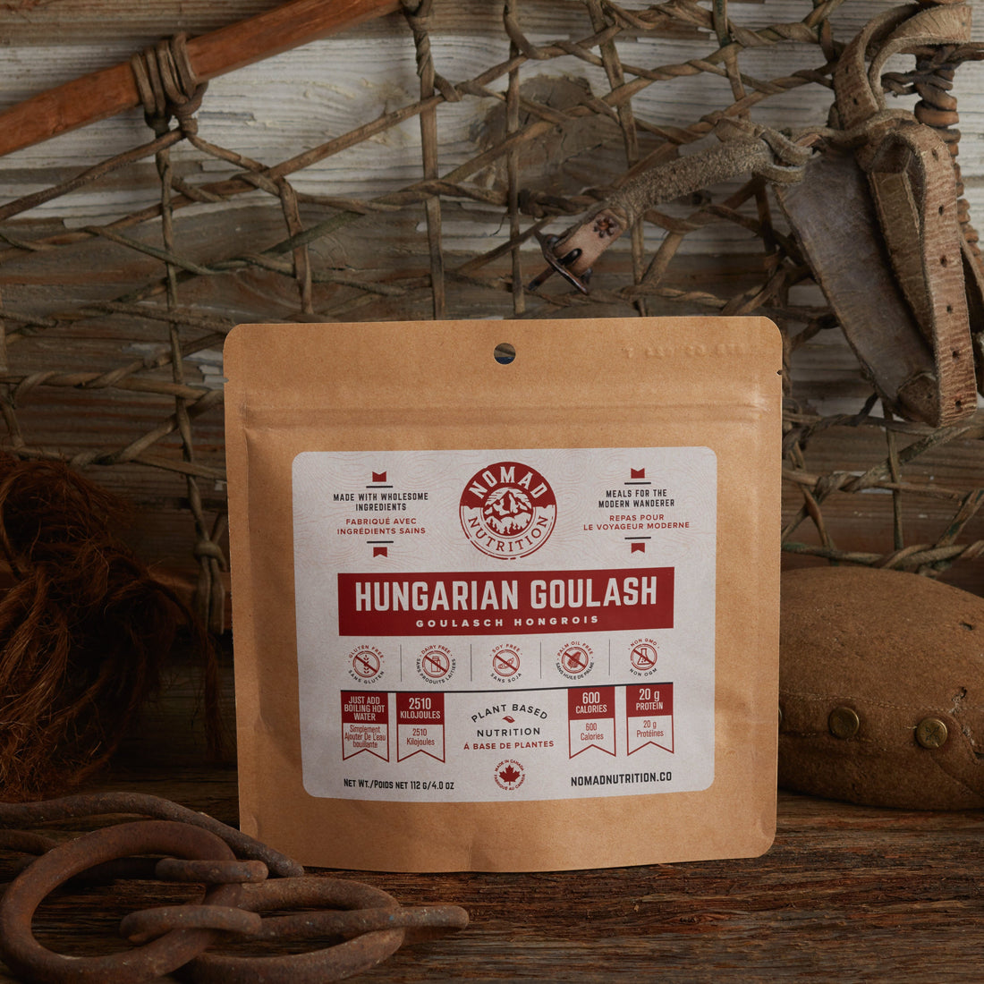 Nomad Nutrition Hungarian Goulash 112g meal size with outdoor equipments on table top.