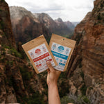 Nomad Nutrition Indian Red Lentil Stew and Carribean Curry (56g/ 2oz), dehydrated vegan adventure plant-based, gluten-free meal overlooking the scenic canyon valley at Arches National Park.
