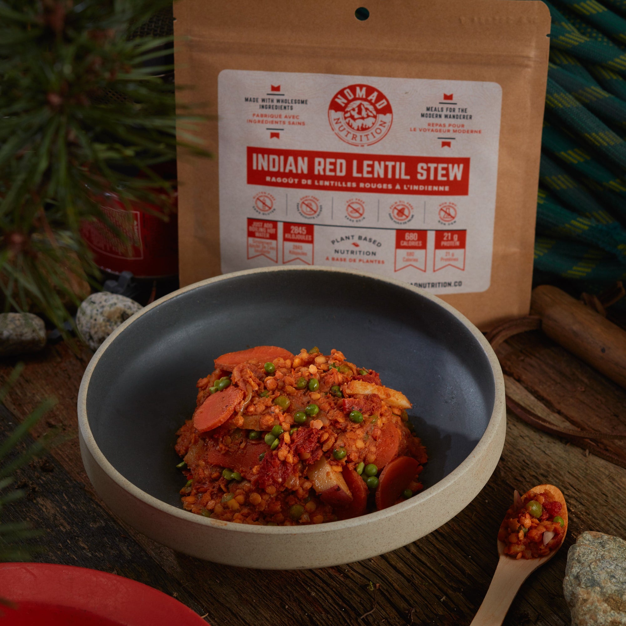 Rehydrated Nomad Nutrition Indian Red Lentil Stew in a bowl with 112g meal size on table top outdoors. No additional cooking required.