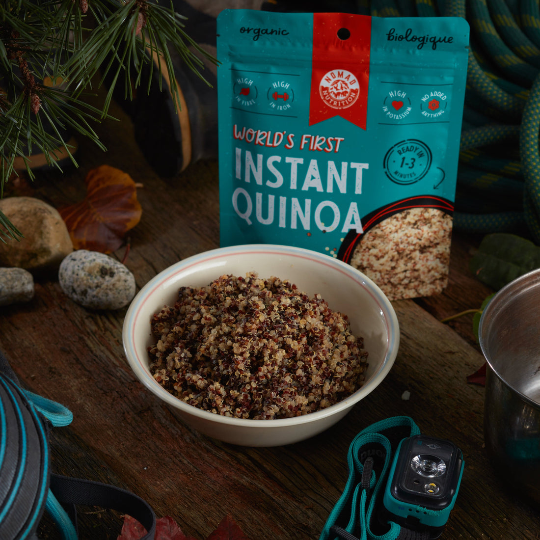Rehydrated Nomad Nutrition Instant Quinoa in a bowl with 112g meal size on table top outdoors. No additional cooking required. Cooks in 1-3 minutes. Organic tricolor Bolivian quinoa grain. 