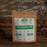 Nomad Nutrition Irish Shepherd's Pie 56g snack size with outdoor equipments on table top.