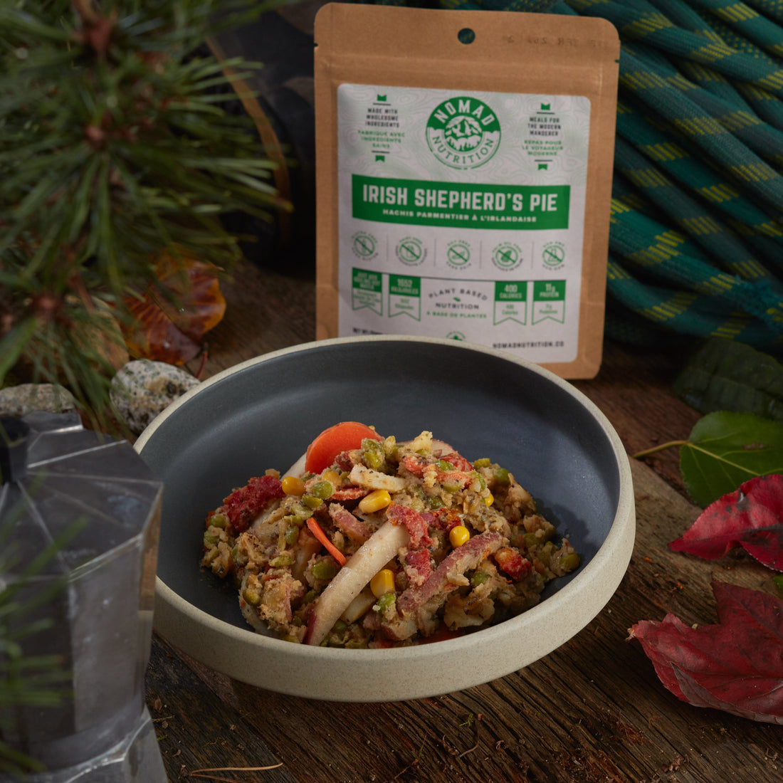 Rehydrated Nomad Nutrition Irish Shepherd's Pie in a bowl with 56g snack size on table top outdoors. No additional cooking required. 