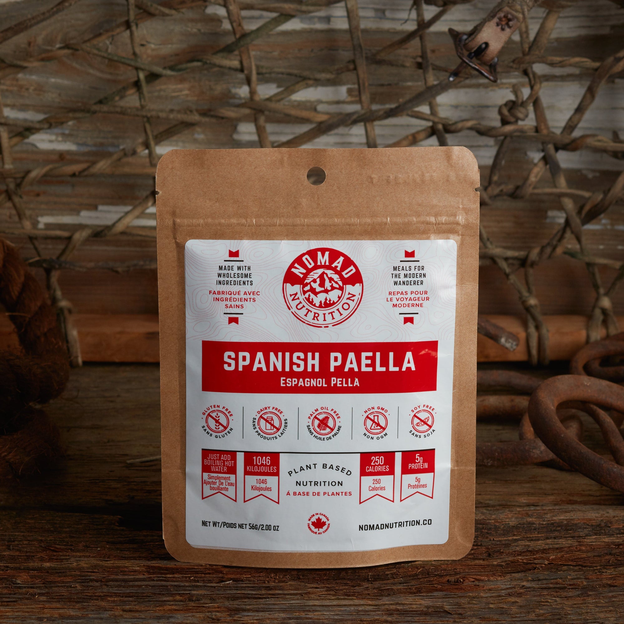 Nomad Nutrition Spanish Paella 56g snack size with outdoor equipments on table top.