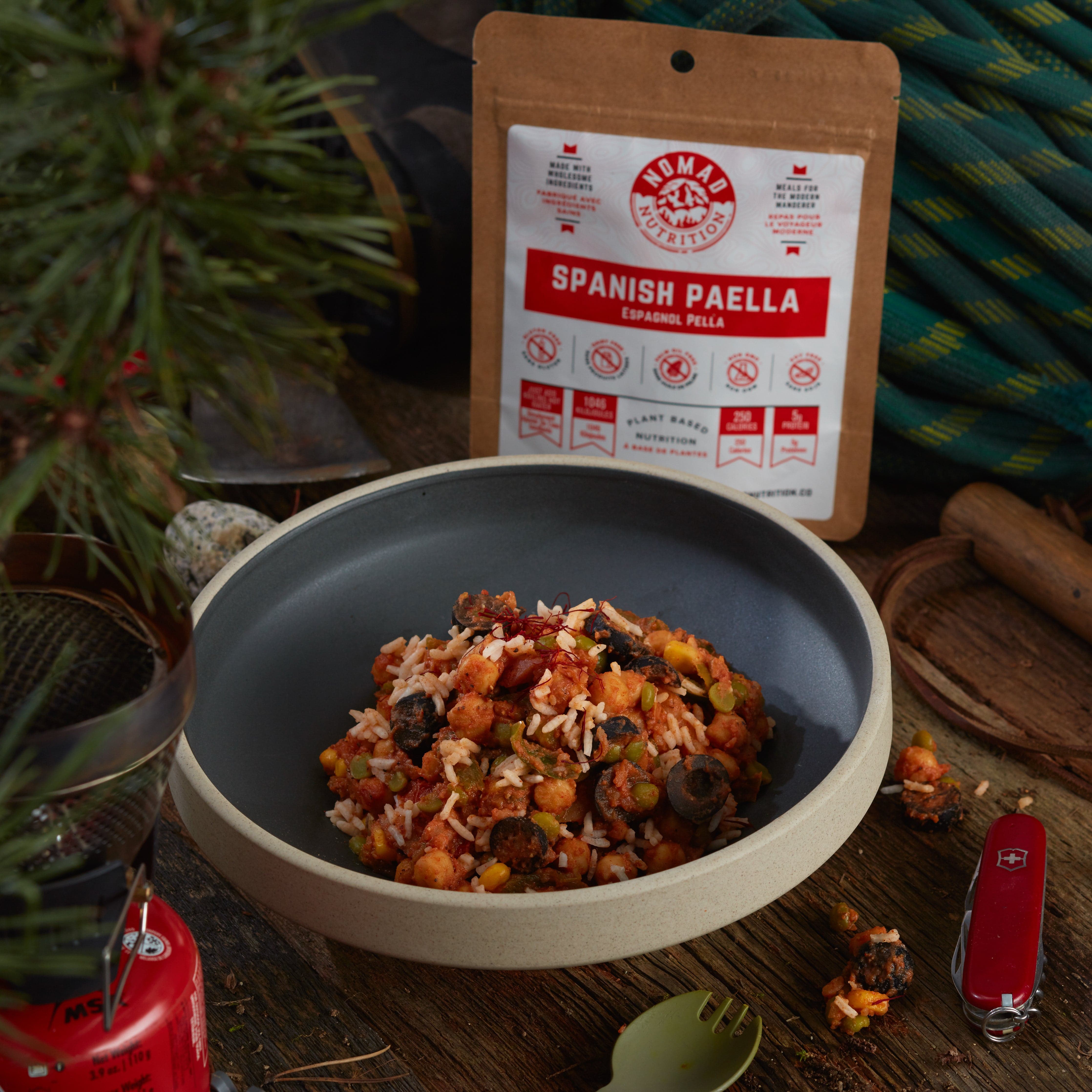Rehydrated Nomad Nutrition Spanish Paella in a bowl with 56g snack size on table top outdoors. No additional cooking required. 